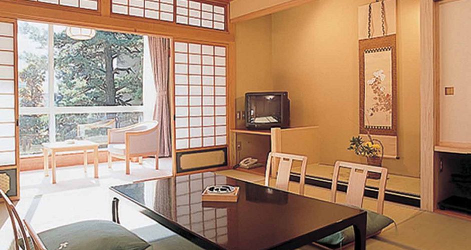 Staying in a Japanese Ryokan (traditional hotel) adds to the cultural experience. Staying in a Japanese Ryokan (traditional hotel) adds to the cultural experience. - image 0